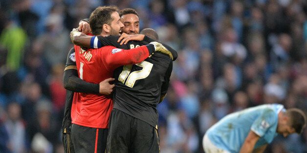 Wigan Athletic's English goalkeeper Scott Carson (L) joins his teammates in celebrating at the final whistle during the English FA Cup quarter-final football match between Manchester City and Wigan Athletic at the Etihad Stadium in Manchester, northwest England, on March 9, 2014. Wigan won 2-1. AFP PHOTO / PAUL ELLISRESTRICTED TO EDITORIAL USE. No use with unauthorized audio, video, data, fixture lists, club/league logos or 'live' services. Online in-match use limited to 45 images, no video em