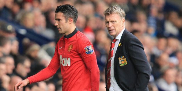 Manchester United's Robin van Persie walks past manager David Moyes after being substituted