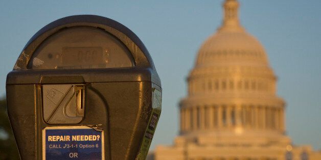 The US Congress building is seen behind a parking meter in Washington, DC, October 14, 2013. The crisis over a US government shutdown and debt ceiling standoff continues into the third week of the shutdown. With just three days before the US Treasury exhausts its borrowing authority, and the government entering its third week of a crippling shutdown, lawmakers have scrambled to work out a deal that would resolve both crises. AFP PHOTO/ MLADEN ANTONOV (Photo credit should read MLADEN ANT