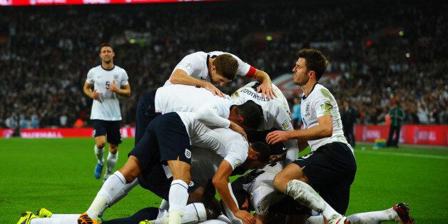 LONDON, ENGLAND - OCTOBER 15: Wayne Rooney of England celebrates with team mates after scoring his team's opening goal during the FIFA 2014 World Cup Qualifying Group H match between England and Poland at Wembley Stadium on October 15, 2013 in London, England. (Photo by Laurence Griffiths/Getty Images)