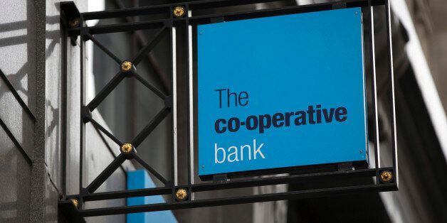 A logo sits on a sign outside a Co-Operative Bank Plc bank branch in London, U.K., on Friday, Nov. 29, 2013. Co-Operative Bank Plc, which is trying to plug a 1.5 billion-pound ($2.5 billion) capital shortfall, needs two-thirds of holders of its undated junior debt to vote on a debt-for-equity swap for it to be valid, according to company filings. Photographer: Simon Dawson/Bloomberg via Getty Images