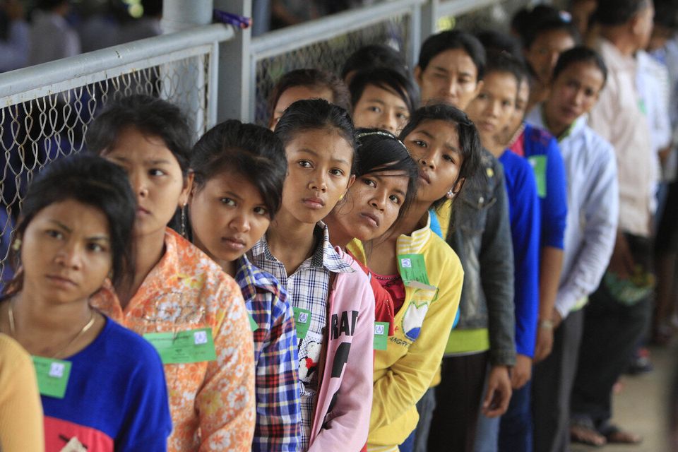 Cambodian villagers line up at the court before the final statement