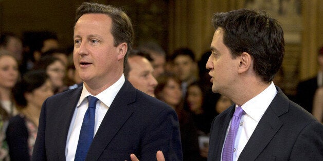 British Prime Minster David Cameron (L) and Ed Miliband, the Leader of the Labour Party, walk through the Members' Lobby to listen to the Queen's Speech at the State Opening of Parliament on May 8, 2013. Heir to the throne Prince Charles and his wife Camilla attended the state opening of Britain's parliament alongside Queen Elizabeth II on Wednesday, in a sign of their increasing role as the 87-year-old monarch scales back some of her duties. AFP PHOTO / ALASTAIR GRANT/POOL (Photo credi