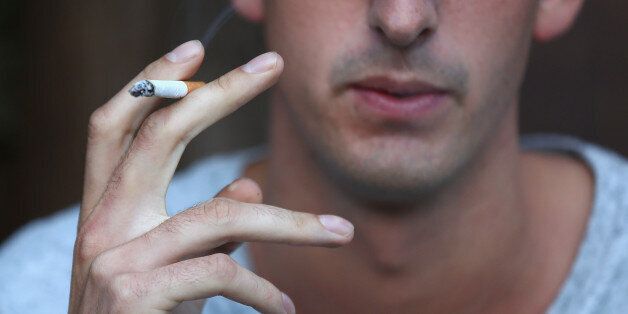 SYDNEY, AUSTRALIA - AUGUST 01: In this photo illustration a man smokes on August 1, 2013 in Sydney, Australia. In a plan announced today, the government will increase the excise on tobacco by 12.5 per cent annually over the next four years, raising over AUD$5 billion. The hike is estimated to increase the cost of cigarettes by AUD$5 by 2016, and is the first increase in the tobacco excise since 2010. (Photo by Cameron Spencer/Getty Images)