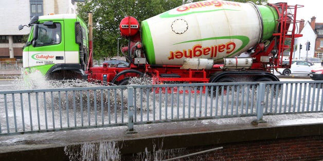 A lorry passes through a flash flood following a heavy rain shower in Maidstone, Kent.