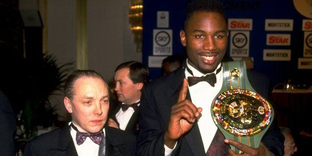 1992: Heavyweight boxer Lennox Lewis of Great Britain shows off his WBC belt with his manager Frank Maloney. \ Mandatory Credit: Gray Mortimore/Allsport