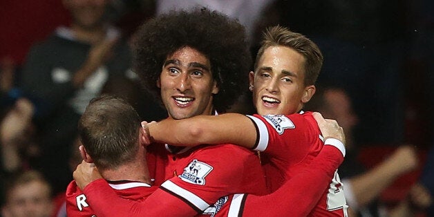 Manchester United's Scottish midfielder Darren Fletcher (2nd R) celebrates scoring the opening goal with teammates during the pre-season football friendly match between Manchester United and Valencia at Old Trafford in Manchester. north west England on August 12, 2014. AFP PHOTO/PAUL ELLISRESTRICTED TO EDITORIAL USE. NO USE WITH UNAUTHORIZED AUDIO, VIDEO, DATA, FIXTURE LISTS, CLUB/LEAGUE LOGOS OR LIVE SERVICES. ONLINE IN-MATCH USE LIMITED TO 45 IMAGES, NO VIDEO EMULATION. NO USE IN BETTING, GAME