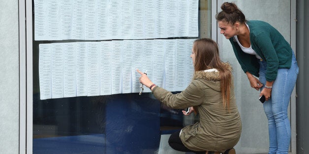 Molly Taylor (left) and Yasmin Clews check their A-level results at Worcester Sixth Form College, as official figures show that more A-levels were handed the very highest grade this summer, but the overall pass rate fell for the first time in more than 30 years.