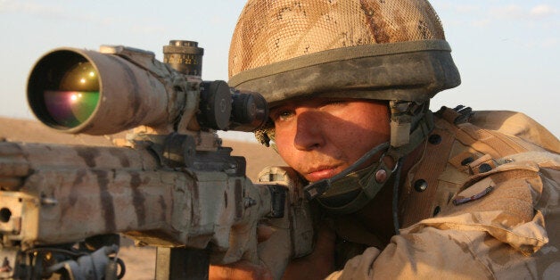 British army sniper peers through the scope of his rifle, to scan the horizon for suspected Taliban insurgents, north of Musa Qala in Helmand, Afghanistan.Musa Qala town was one of the most bitterly contested parts of Helmand, which itself was one of the most dangerous places in Afghanistan. Hundreds of British and American soldiers and marines, and countless Afghan civilians, were killed in gun battles, ambushes, air strikes and by improvised explosive devices after the US led invasion toppled the Taliban regime in 2001.