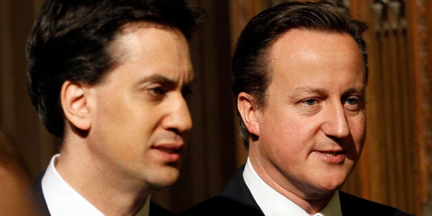 Britain's Prime Minister David Cameron (R) and opposition Labour Party leader Ed Miliband (L) walk together through the Members' Lobby of the House of Commons in the Palace of Westminster toward the Chamber of the House of Lords during the State Opening of Parliament in London May 9, 2012 Britain's Queen Elizabeth II unveiled the coalition government's legislative programme in a speech delivered to Members of Parliament and Peers in The House of Lords. AFP PHOTO / POOL / STEFAN WERMUTH