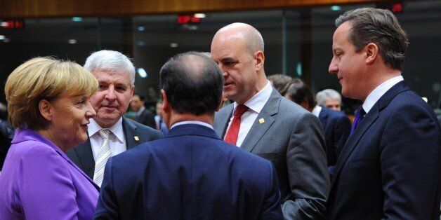 David Cameron speaks with other EU leaders at the Brussels summit