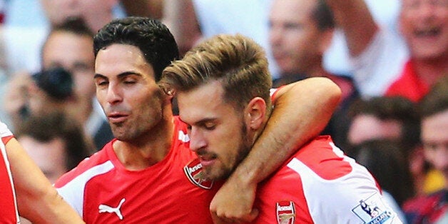 LONDON, ENGLAND - AUGUST 16: Aaron Ramsey (R) of Arsenal celebrates his goal with team mate Mikel Arteta during the Barclays Premier League match between Arsenal and Crystal Palace at Emirates Stadium on August 16, 2014 in London, England. (Photo by Clive Mason/Getty Images)