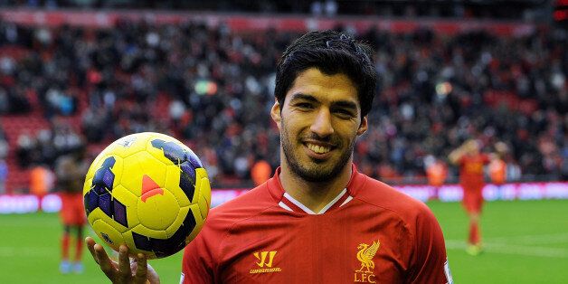 LIVERPOOL, ENGLAND - OCTOBER 26: ( THE SUN OUT, THE SUN ON SUNDAY OUT) Luis Suarez of Liverpool poses with the match ball after scoring a hat trick at the end of the Barclays Premier League match between Liverpool and West Bromwich Albion at Anfield on October 26, 2013 in Liverpool, England. (Photo by John Powell/Liverpool FC via Getty Images)