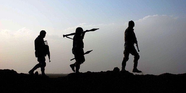 Afghan National Army (ANA) soldiers walk during an operation in Guzara district of Herat on January 26, 2010. NATO-led and US forces are suffering almost daily casualties battling the Taliban in the south with last year their bloodiest yet. The United States is to pour an additional 30,000 troops into Afghanistan this year, in addition to the 70,000 it already has there, and other countries are also to step up troop numbers. AFP PHOTO/Aref Karimi (Photo credit should read Aref Karimi/AFP/Getty