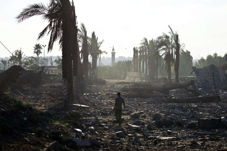 A zookeeper walks in the rubble at the zoo entrance 