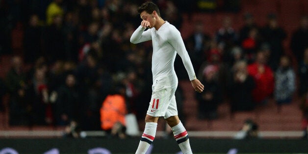 LONDON, ENGLAND - OCTOBER 29: Mesut Ozil of Arsenal walks off the pitch after his side lost the Capital One Cup Fourth Round match between Arsenal and Chelsea at the Emirates Stadium on October 29, 2013 in London, England. (Photo by Jamie McDonald/Getty Images)