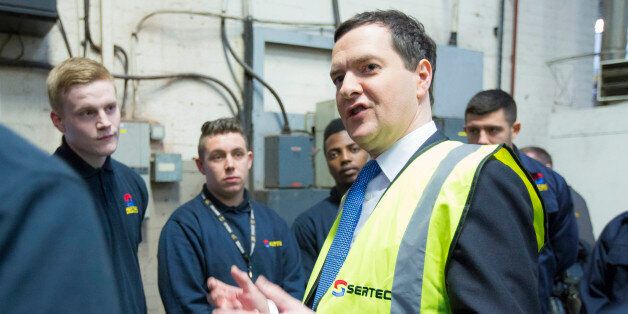 George Osborne, U.K. chancellor of the exchequer, center, gestures as he speaks with apprentices at Sertec Group Holdings Ltd. employees at the company's automotive parts plant, in Birmingham, U.K., on Monday, Jan. 6, 2014. Osborne set out his plan to ease the burden on families while reiterating his goal to shrink the deficit as he says tax cuts will have to be funded by spending reductions. Photographer: Jason Alden/Bloomberg via Getty Images