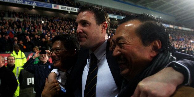 CARDIFF, WALES - JANUARY 24: Malky Mackay the Cardiff City manager celebrates with club owner Tan Sri Vincent Tan Chee Yioun (right) and chairman Chan Tien Ghee (left) following his team's 3-1 victory in the penalty shootout during the Carling Cup Semi Final second leg match between Cardiff City and Crystal Palace at Cardiff City Stadium on January 24, 2012 in Cardiff, Wales. (Photo by Michael Steele/Getty Images)