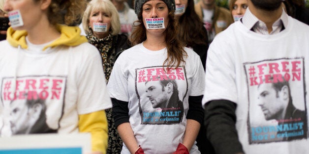 Demonstrators take part in a silent protest outside the Russian embassy in west London on November 2, 2013, in support of Kieron Bryan, a journalist currently being held in a Russian prison. Kieron Bryan was among 30 environmentalists on board Greenpeace's Arctic Sunrise ship, arrested by Russian forces in a commando-style operation when two activists tried to scale an oil rig on September 18. AFP PHOTO/LEON NEAL (Photo credit should read LEON NEAL/AFP/Getty Images)