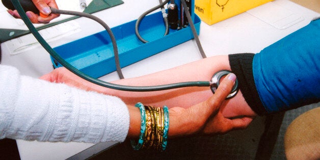 GP taking female patient's blood pressure in health centre, Reading UK. (Photo by: Photofusion/UIG via Getty Images)