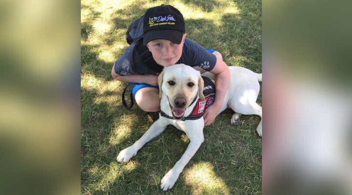 Cameron Cadarette poses with his service dog, Vincent.