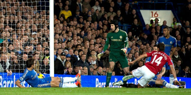 Manchester United's Mexican striker Javier Hernandez (R) scores their third goal during the English Premier League football match between Chelsea and Manchester United at Stamford Bridge in London, on October 28, 2012. AFP PHOTO/ADRIAN DENNISRESTRICTED TO EDITORIAL USE. No use with unauthorized audio, video, data, fixture lists, club/league logos or ?live? services. Online in-match use limited to 45 images, no video emulation. No use in betting, games or single club/league/player publications.