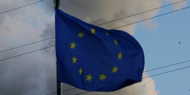 BERLIN - MARCH 19: An European (EU) flag seen near the smoking power plant in Berlin Spandau on March 19, 2007 in Berlin, Germany. Dirty air, dirty water, mosquitoes - 13 million persons in the year must die according to the world health organization (WHO) as they live in a pollutet environment. (Photo by Andreas Rentz/Getty Images)