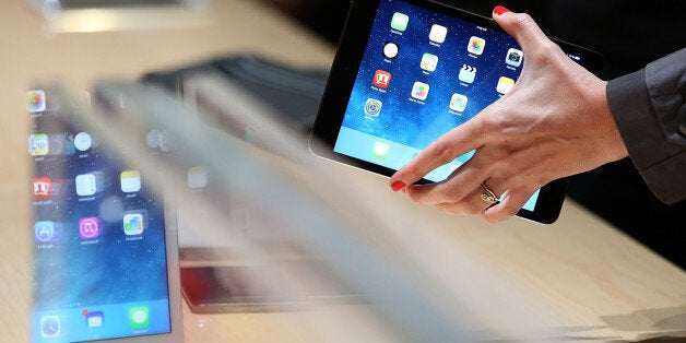 SAN FRANCISCO, CA - OCTOBER 22: An attendee looks at the new iPad Mini during an Apple announcement at the Yerba Buena Center for the Arts on October 22, 2013 in San Francisco, California. The tech giant announced its new iPad Air, a new iPad mini with Retina display, OS X Mavericks and highlighted its Mac Pro. (Photo by Justin Sullivan/Getty Images)