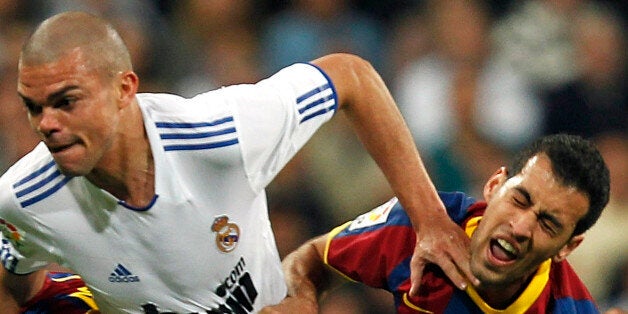 MADRID, SPAIN - APRIL 16: Pepe of Real Madrid duels for the ball with Sergio Busquets (R) and David Villa of Barcelona during the La Liga match between Real Madrid and Barcelona at Estadio Santiago Bernabeu on April 16, 2011 in Madrid, Spain. (Photo by Angel Martinez/Real Madrid via Getty Images)