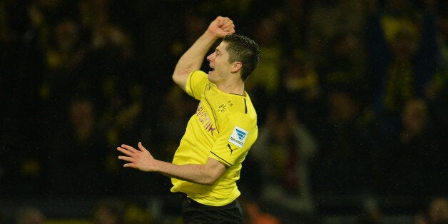 Dortmund's Polish striker Robert Lewandowski celebrates during the German first division Bundesliga football match Borussia Dortmund vs VfB Stuttgart in Dortmund, western Germany on November 1, 2013. AFP PHOTO / PATRIK STOLLARZ DFL RULES TO LIMIT THE ONLINE USAGE DURING MATCH TIME TO 15 PICTURES PER MATCH. FOR FURTHER QUERIES PLEASE CONTACT DFL DIRECTLY AT + 49 69 650050. (Photo credit should read PATRIK STOLLARZ/AFP/Getty Images)