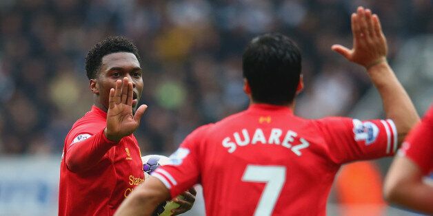 NEWCASTLE UPON TYNE, ENGLAND - OCTOBER 19: Daniel Sturridge of Liverpool high fives Luis Suarez of Liverpool during the Barclays Premier League match between Newcastle United and Liverpool at St James' Park on October 19, 2013 in Newcastle upon Tyne, England. (Photo by Julian Finney/Getty Images)