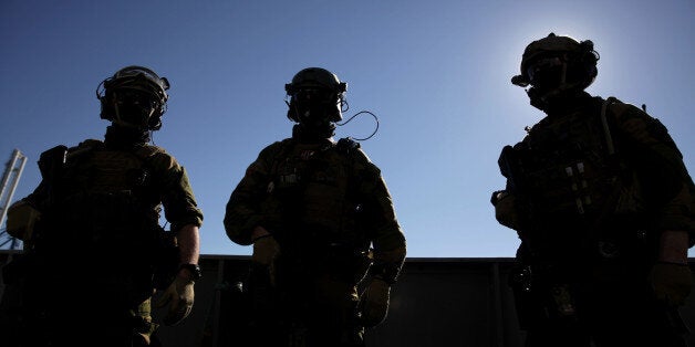 Norwegian soldiers from the vessel protection team stand on the Norwegian naval frigate 'Hnoms Helge Ingstad'