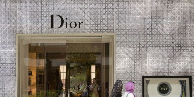 Pedestrians pass the entrance and display window of a Dior luxury fashion store, operated by Christian Dior SA, in the Zorlu shopping mall in Istanbul, Turkey