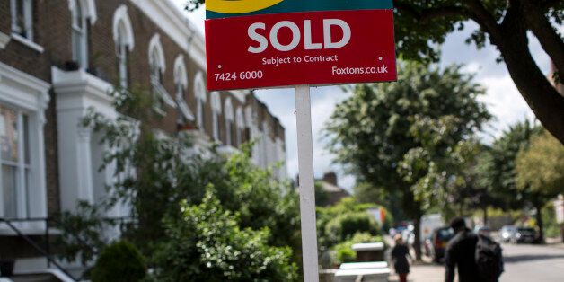 LONDON, ENGLAND - JUNE 03: An estate agent sold sign is displayed outside a property on June 3, 2014 in London, England. Figures from the Nationwide, the UK's largest building society, have shown that in the year to May, the annual rise in house prices was 11.1% which represents the greatest rate of increase in seven years. (Photo by Oli Scarff/Getty Images)