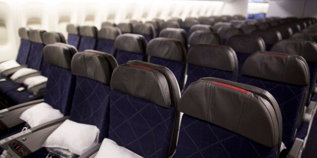 Seats in the economy class cabin on board an American Airlines plane. A flight from Miami-to-Paris has been forced to divert to Boston after a violent outburst over a reclined seat