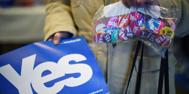 ALEXANDRIA, SCOTLAND - AUGUST 28: An elderly woman holds a bag of badges in a Yes campaign shop on August 28, 2014 in Alexandria, Scotland. In less than a month voters will go to the polls to vote yes or no on whether Scotland should become an independent country. (Photo by Jeff J Mitchell/Getty Images)