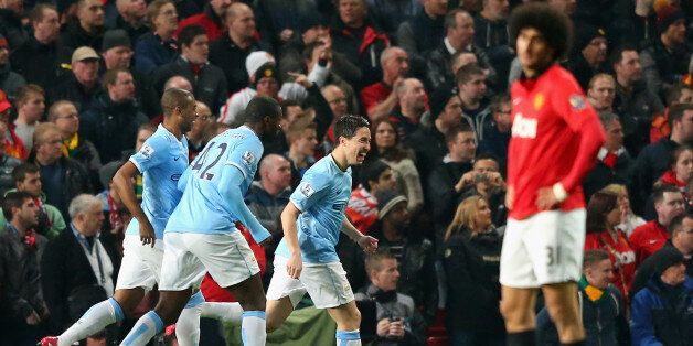 MANCHESTER, ENGLAND - MARCH 25: Samir Nasri of Manchester City celebrates with his team-mates after Edin Dzeko scored the opening goal during the Barclays Premier League match between Manchester United and Manchester City at Old Trafford on March 25, 2014 in Manchester, England. (Photo by Alex Livesey/Getty Images)