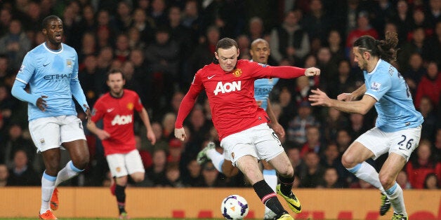 MANCHESTER, ENGLAND - MARCH 25: Wayne Rooney of Manchester United in action with Martin Demichelis of Manchester City during the Barclays Premier League match between Manchester United and Manchester City at Old Trafford on March 25, 2014 in Manchester, England. (Photo by Matthew Peters/Man Utd via Getty Images)