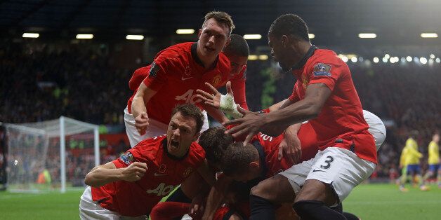 MANCHESTER, ENGLAND - NOVEMBER 10: Robin van Persie of Manchester United celebrates scoring their first goal during the Barclays Premier League Match between Manchester United and Arsenal at Old Trafford on November 10, 2013 in Manchester, England. (Photo by Tom Purslow/Man Utd via Getty Images)