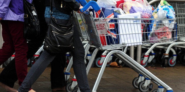 File photo dated 31/12/13 of customers with their shopping leave a Tesco store as Britain's biggest supermarket is expected to post a third successive quarter of worsening sales when latest trading figures are published.