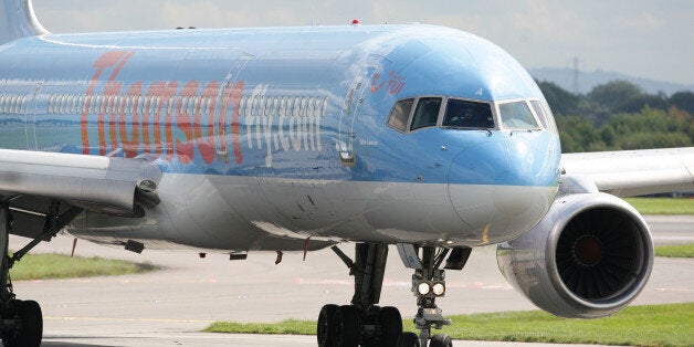 A Thomson plane lands at Manchester Airport.