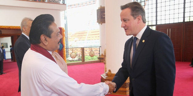 COLOMBO, SRI LANKA - NOVEMBER 15: President Mahinda Rajapaksa of Sri Lanka greets British Prime Minister David Cameron ahead of the Commonwealth Heads of Government 2013 Opening Ceremony on November 15, 2013 in Colombo, Sri Lanka. The biannual Commonwealth Heads of Government Meeting (CHOGM) is taking place from November 15-17, amid pressure from human rights groups urging leaders to boycott the summit until Sri Lanka further investigates charges of war crimes. Both the Canadian Prime Minister,