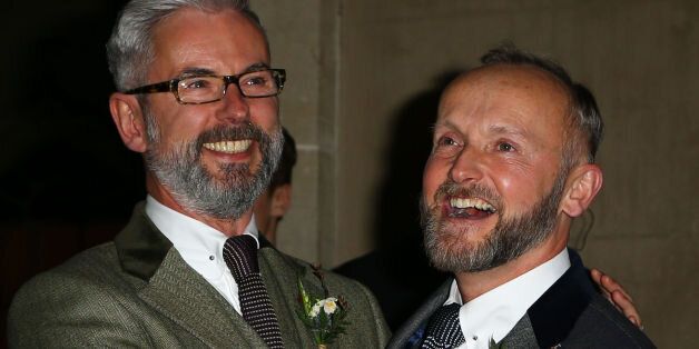 Actor Andrew Wale (left) and guesthouse owner Neil Allard pose for photographs following their wedding service in the Music Room of the Royal Pavilion, Brighton, as the new law permitting same sex marriage in England and Wales comes into force.