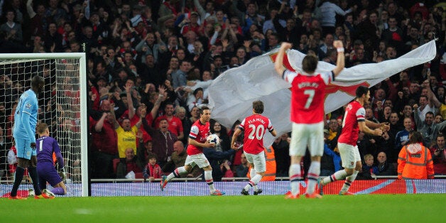 LONDON, ENGLAND - MARCH 29: Joe Hart and Yaya Toure of Manchester City look on as Mathieu Flamini of Arsenal celebrates scoring their first goal with Santi Cazorla of Arsenal during the Barclays Premier League match between Arsenal and Manchester City at Emirates Stadium on March 29, 2014 in London, England. (Photo by Shaun Botterill/Getty Images)