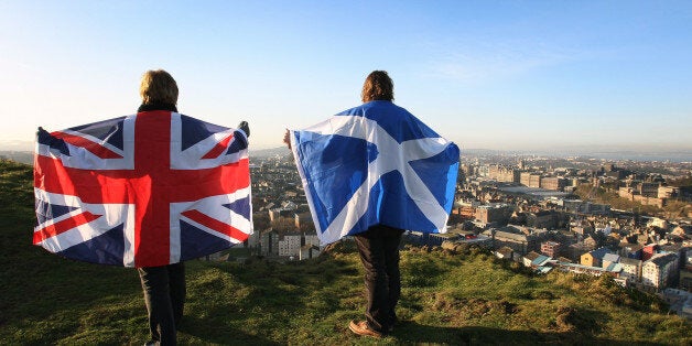 Scottish and English flags held up over Edinburgh, Scotland