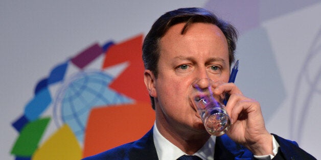 British Prime Minister David Cameron sips water during a press conference held on the second day of the Commonwealth Heads Of Government Meeting (CHOGM) in Colombo on November 16, 2013. Britain's David Cameron put Sri Lanka on notice November 16 to address allegations of war crimes within months or else he would lead a push for action at the United Nations. AFP PHOTO/ Ishara S.KODIKARA (Photo credit should read Ishara S.KODIKARA/AFP/Getty Images)