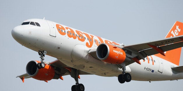 SCHOENEFELD, GERMANY - AUGUST 16: A passenger plane of discount airline easyJet arrives at Schoenefeld Airport, which is adjacent to the new Willy Brandt Berlin Brandenburg International Airport, on August 16, 2013 in Schoenefeld, Germany. The governing authority of the new airport is meeting today and authority head Hartmut Mehdorn is reportedly seeking to begin operation of a portion of the new aiport in the near future. Originally scheduled to begin operation in 2012, the opening was delayed