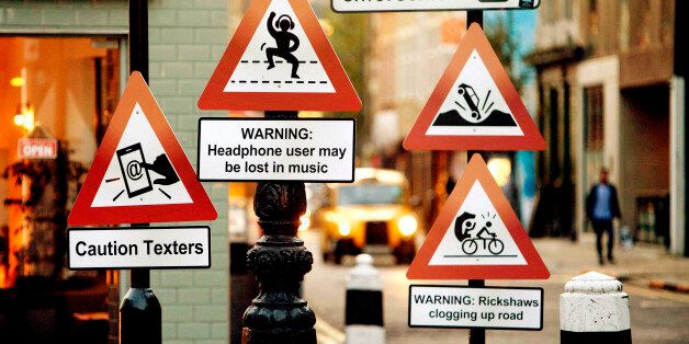 EDITORIAL USE ONLYA variety of 'road signs' positioned on a London street depicting the up to date hazards that Hailo taxi drivers believe should be part of the Highway Code.