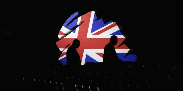 MANCHESTER, ENGLAND - OCTOBER 02: Delegates walk past a giant model of the Conservative Party logo before British Prime Minister David Cameron delivers his keynote speech to delegates on the last day of the annual Conservative Party Conference at Manchester Central on October 2, 2013 in Manchester, England. During his closing speech David Cameron said that his 'abiding mission' would make the UK into a 'land of opportunity'. (Photo by Oli Scarff/Getty Images)