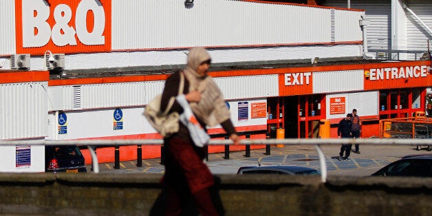 A pedestrian walks past a B&Q home improvement store, operated by Kingfisher Plc, in Manchester, U.K., on Monday, March 24, 2014. Kingfisher, the owner of the B&Q DIY chain, may announce a dividend for shareholders or share buyback option at its annual results, the Financial Times newspaper reported last week. Photographer: Paul Thomas/Bloomberg via Getty Images